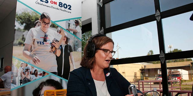 Amber England, campaign manager, Yes on 802, addresses supporters via the internet Tuesday, June 30, 2020, in Oklahoma City, as due to Covid-19 concerns, a virtual watch party replaces the normal watch party, as they await results in a vote in which Oklahoma voters are deciding whether to amend the state Constitution to expand Medicaid health coverage to tens of thousands of low-income residents. (AP Photo/Sue Ogrocki)