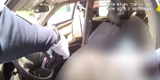 Bodycam footage shows an officer putting on surgical gloves, moving towards Garcia, and pulling a handgun out of the vehicle.