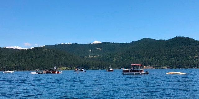 Boaters reacting to the crash near Powderhorn Bay on Lake Coeur d'Alene on Sunday, south of Coeur d'Alene, Idaho.