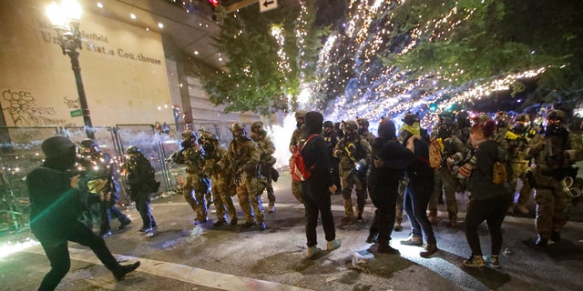 Federal officers advance on demonstrators during a Black Lives Matter protest at the Mark O. Hatfield US Courthouse, July 25, 2020.<strong> </strong> (AP Photo/Marcio Jose Sanchez)