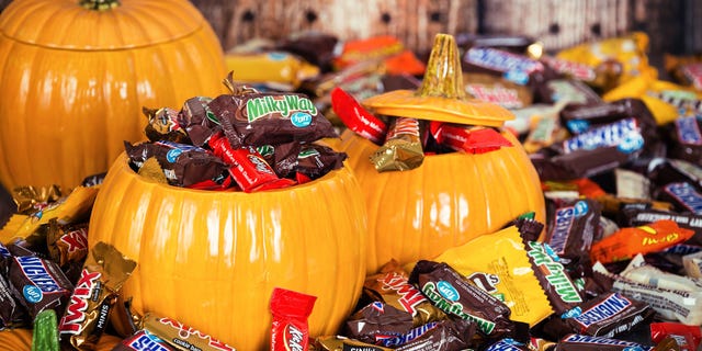 A person handing out candy can stand at the tall end and slide the treats down to eager trick-or-treaters waiting with their pumpkin buckets or pillowcases at the other end.
