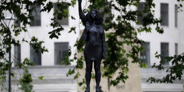 A new statue entitled "A Surge of Power (Jen Reid) 2020" stands after it was put up this morning on the empty base of the toppled statue of 17th-century slave trader Edward Colston in Bristol, England. (AP)