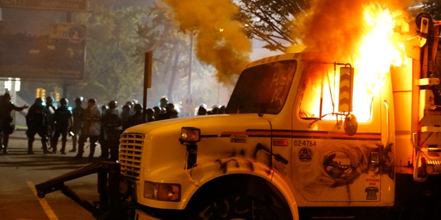 Virginia newspaper calls out local leaders after Richmond riots: 'Enough is enough' 2 Police stand in front of a utility vehicle that was set on fire by protesters during a demonstration outside the Richmond Police Department headquarters on Grace Street in Richmond, Va., Saturday, July 25, 2020. Police deployed flash-bangs and pepper spray to disperse the crowd after the city utility vehicle was set on fire.