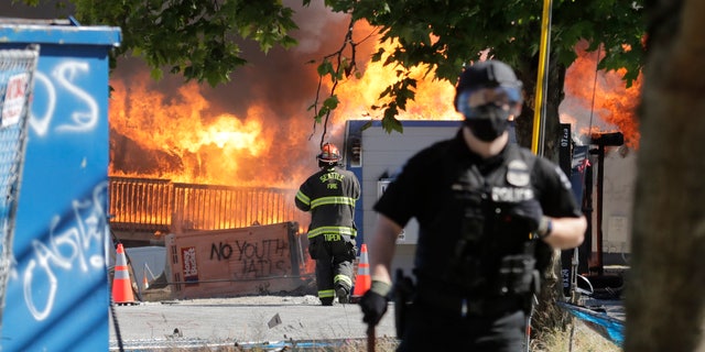 Construction buildings burn near the King County Juvenile Detention Center on Saturday, shortly after a group of protesters left the area. (AP)