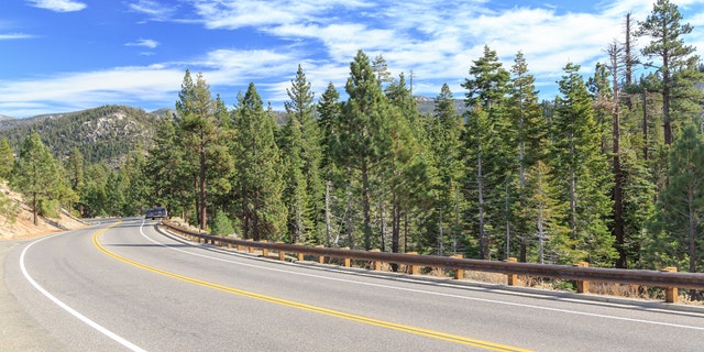 Highway curves through the mountains at Tahoe National Forest, California, USA.