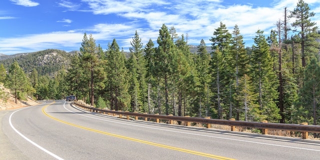 Highway curves through the mountains at Tahoe National Forest, California, USA.