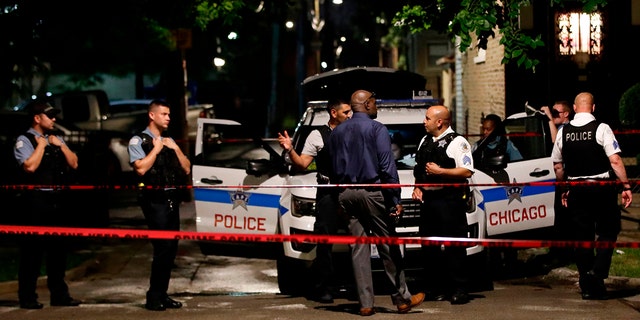 Chicago Police officers investigate the scene of a shooting in Chicago, Illinois, on July 21, 2020.