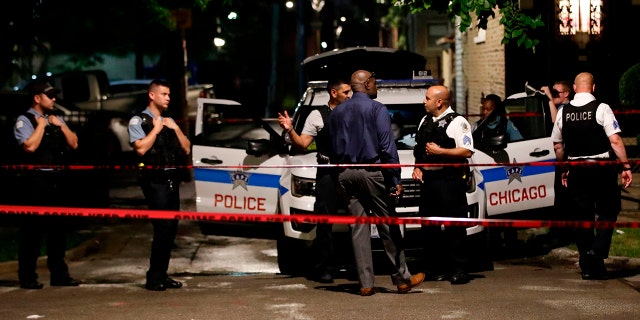 Chicago Police officers investigate the scene of a shooting in Chicago, Illinois, on July 21, 2020.