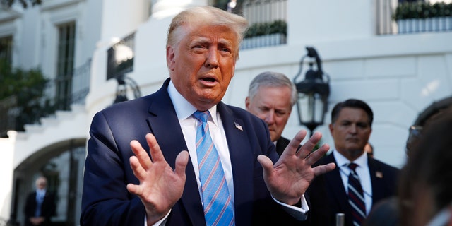 President Donald Trump speaks with reporters as he walks to Marine One on the South Lawn of the White House Wednesday