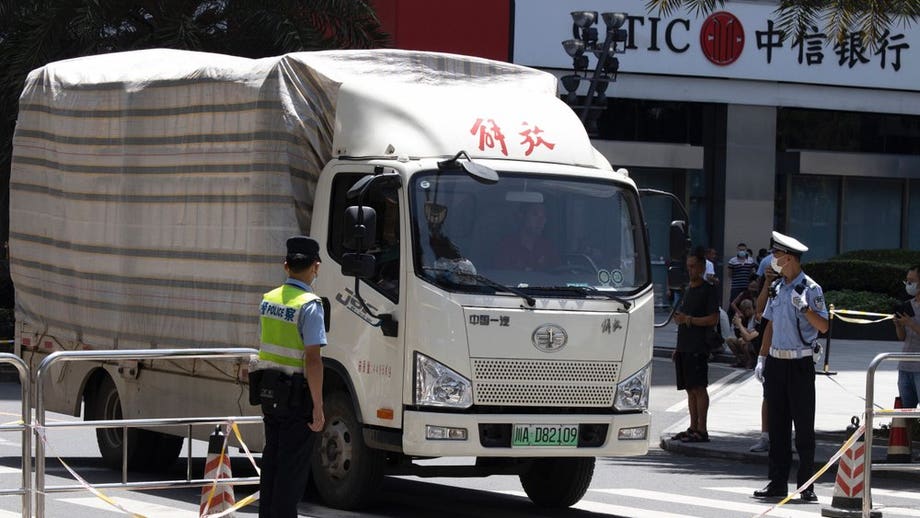 Moving trucks with diplomatic plates spotted leaving US consulate in China as police clear pedestrians