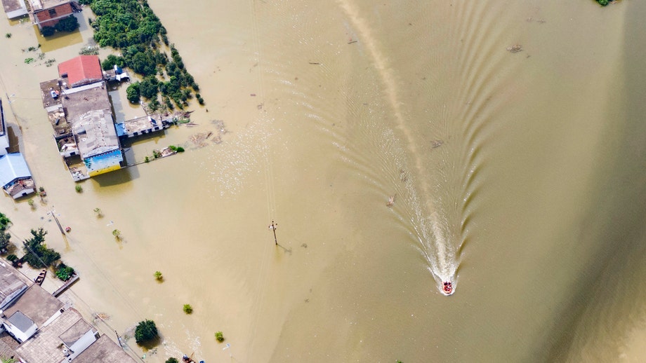 China flooding death toll rises as surging waters trigger new alerts, dam blasted