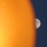 The moon rises behind a street lamp in Weehawken, New Jersey, June 28, 2020. 