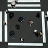 People walk past a pedestrian crossing in Tokyo, July 2, 2020. 