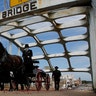 The casket of Rep. John Lewis moves over the Edmund Pettus Bridge by horse-drawn carriage during a memorial service for Lewis in Selma, Ala., July 26, 2020. 