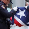 A Mississippi Highway Safety Patrol honor guard carefully folds the retired Mississippi state flag after it was raised over the Capitol grounds one final time in Jackson, Mississippi, July 1, 2020. 