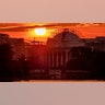 The sun rises behind the scaffolding-clad Jefferson Memorial to begin a hot day in Washington, July 20, 2020.