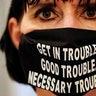 A woman wears a face mask with a quote from the late U.S. Congressman John Lewis at the Georgia State Capitol building, in Atlanta, July 29, 2020. 