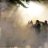 A group of demonstrators huddle as they are tear-gassed by federal officers during a Black Lives Matter protest at the Mark O. Hatfield U.S. Courthouse Tuesday, July 28, 2020, in Portland, Ore.