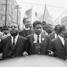Dr. Martin Luther King Jr., center, foreground, locks arms with his aides as he leads a march of several thousands to the courthouse in Montgomery, AL, March 17, 1965. From left are: an unidentified woman, Rev. Ralph Abernathy, James Foreman, King, Jesse Douglas Sr., and John Lewis.