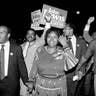 John Lewis, front left, and his wife, Lillian, holding hands, lead a march of supporters from his campaign headquarters to an Atlanta hotel for a victory party after he defeated Julian Bond in a runoff election for Georgia's 5th Congressional District seat in Atlanta, Sept. 3, 1986.