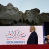 President Donald Trump stands on stage before he speaks at the Mount Rushmore National Monument on July 3, 2020, in Keystone, S.D.