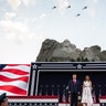 President Donald Trump, accompanied by first lady Melania Trump, stand during a flyover at Mount Rushmore National Memorial on July 3, 2020, near Keystone, S.D.