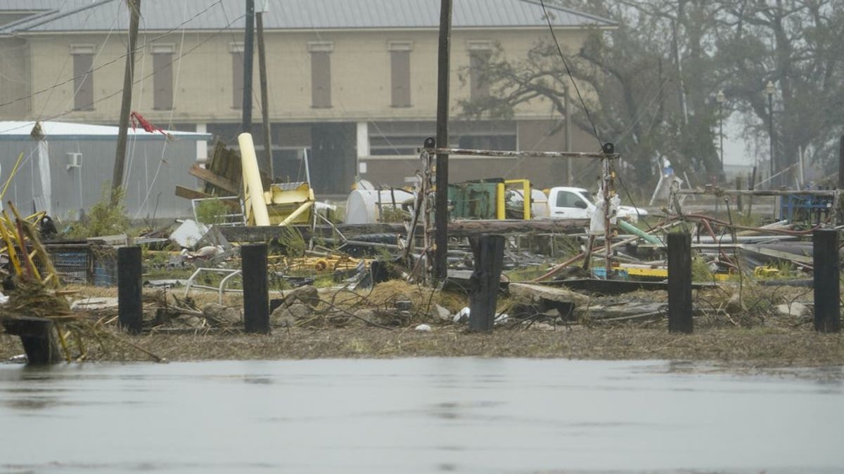 Flooding surrounds damaged homes and buildings Friday, Aug. 28, 2020, in Cameron, La., after Hurricane Laura moved through the area Thursday. (AP Photo/David J. Phillip)