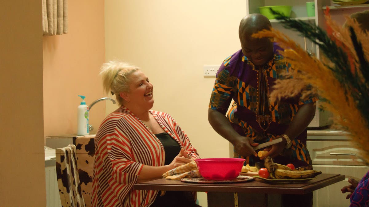 Angela laughs as Michael prepares a meal.