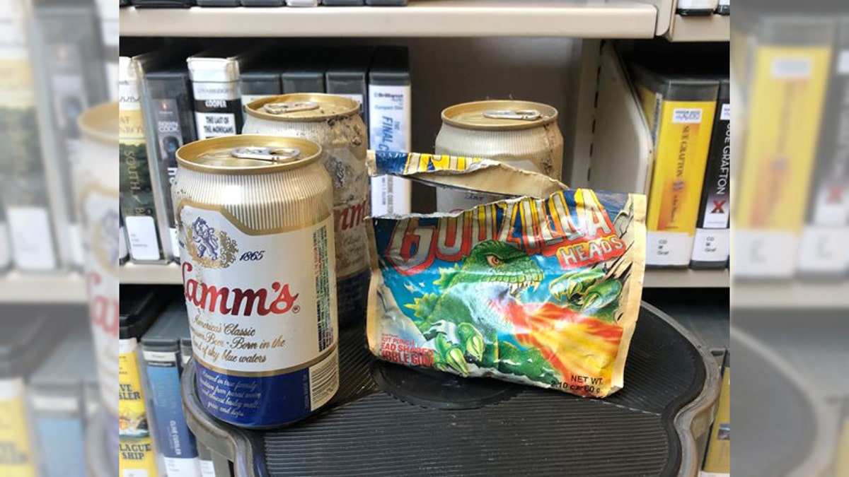 “While moving the [library's] mystery collection to a more accessible place, a facilities crew member uncovered a real-life whodunit when he removed a corner panel on some 1970s-era shelving,” city officials explained earlier this month after finding the beer (above) and some Godzilla-themed gum.