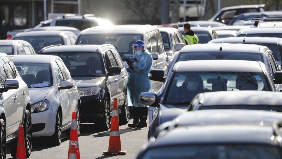 Cars queue at a COVID-19 test centre in Auckland, New Zealand, Thursday, Aug. 13. Health authorities in New Zealand are scrambling to trace the source of a new outbreak of the coronavirus as the nation's largest city goes back into lockdown. (AP Photo/Dean Purcel)