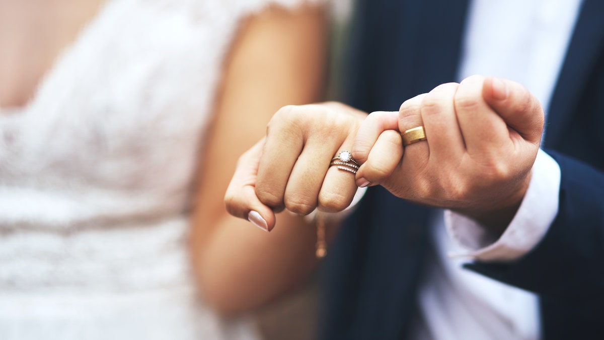 Bride and groom pinky swear