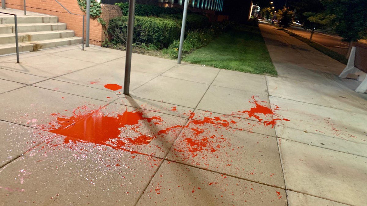 Police released an image of red paint splattered on the sidewalk outside of the department's 5th Precinct after protesters vandalized the building.