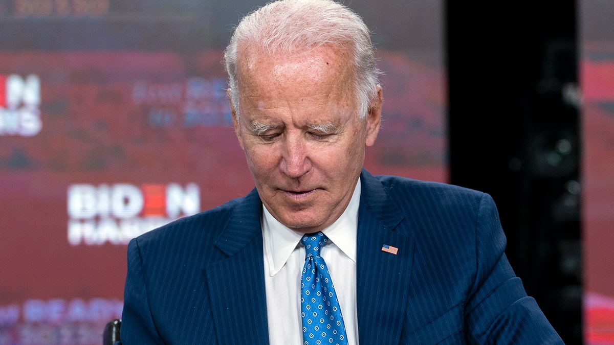 Democratic presidential candidate former Vice President Joe Biden signs a required document for receiving the Democratic nomination for President of the United States in Wilmington, Del., Friday, Aug. 14, 2020. (AP Photo/Carolyn Kaster)