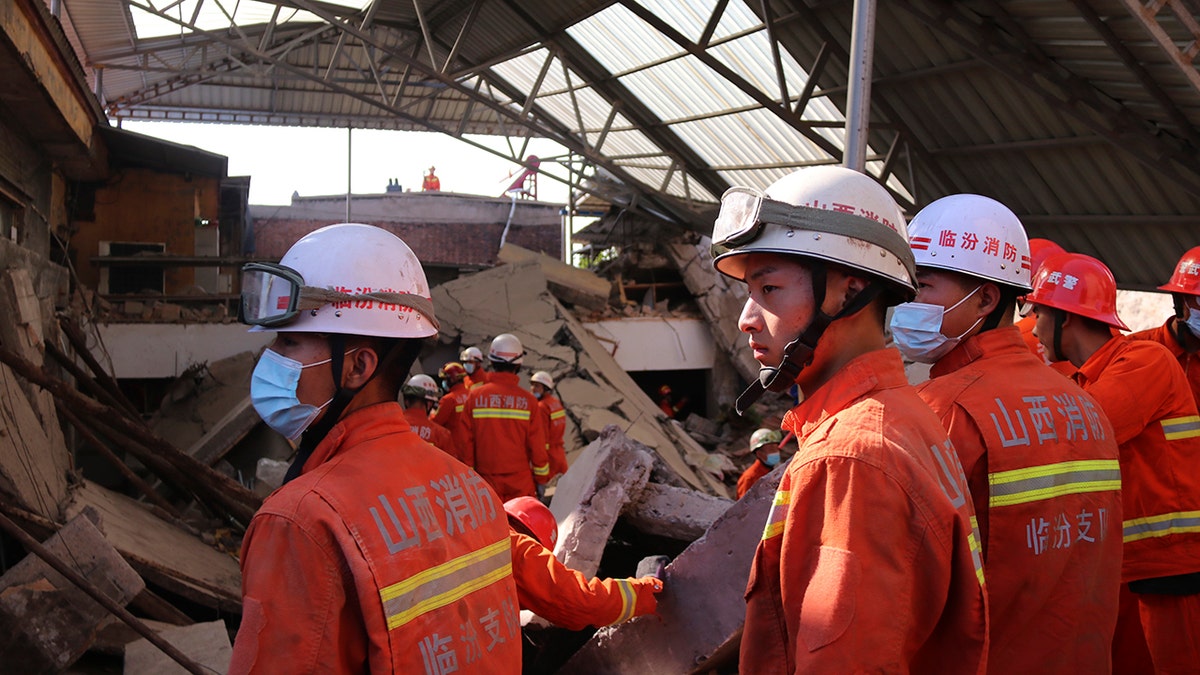 Rescuers search for victims in the aftermath of the collapse of a two-story restaurant in Xiangfen county in northern China's Shanxi province on Saturday, Aug. 29, 2020. (Chinatopix Via AP)