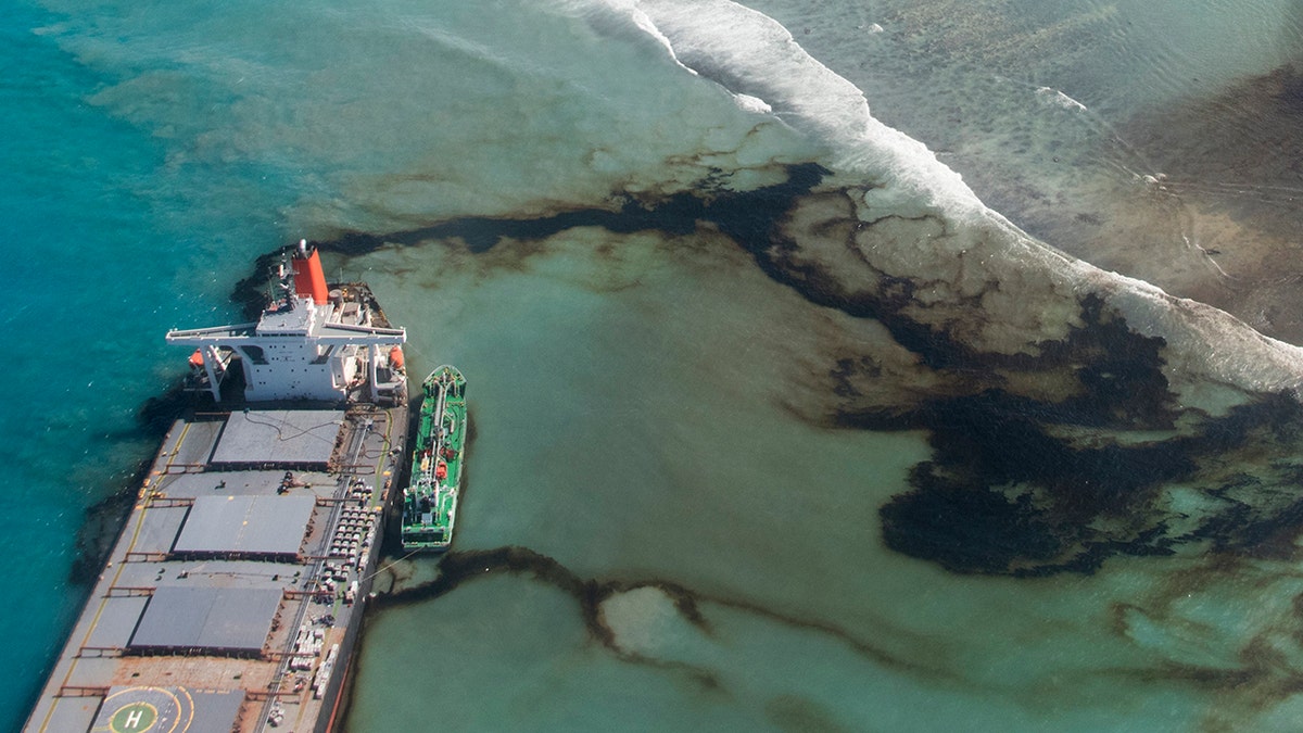 This photo provided by the French Army shows oil leaking from the MV Wakashio, a bulk carrier ship that ran aground off the southeast coast of Mauritius, Tuesday Aug.11, 2020.