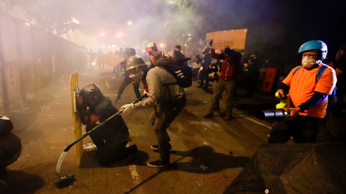 photo shows protesters in Portland, Oregon during the riots of 2020 