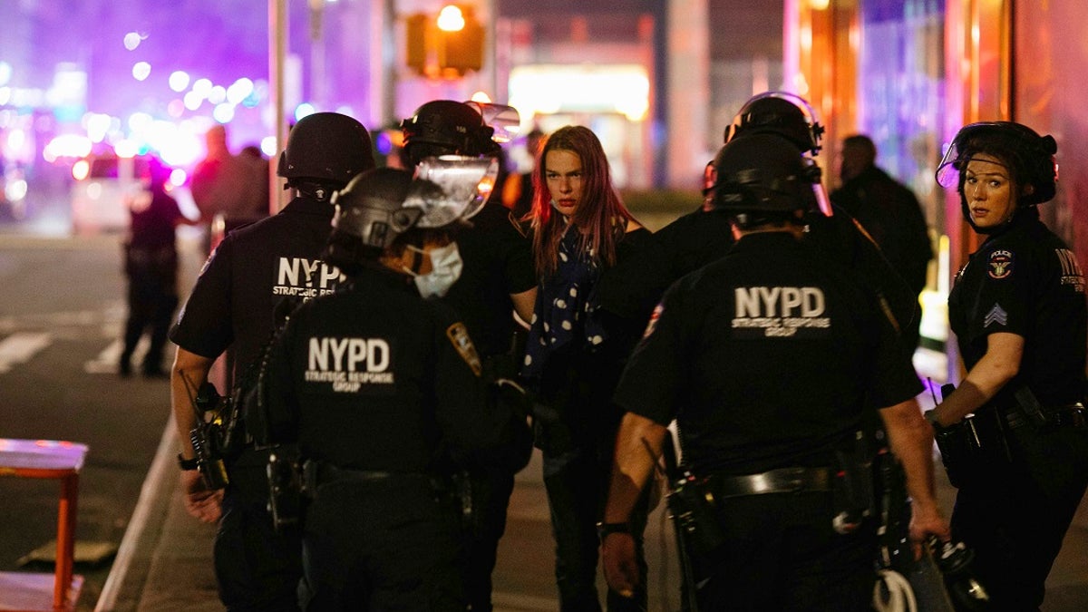 Nikki Stone is detained by police during protests May 31, in New York, against police brutality sparked by the death of George Floyd at the hands of police in Minneapolis. A Gallup poll released Wednesday found that 81% of Black Americans favor a police presence in their neighborhoods at current or increased levels. (AP Photo/Kevin Hagen)