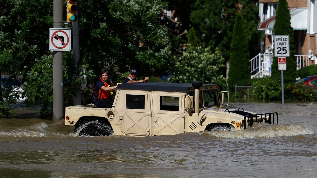 Philadelphia firefighters driving through a flooded neighborhood in the aftermath of Tropical Storm Isaias on Tuesday.