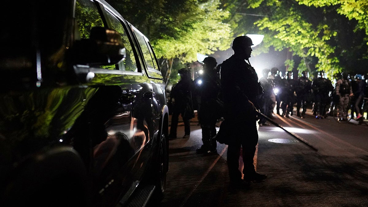 Portland police officers on Saturday, Aug. 8, 2020 in Portland, Ore. (AP Photo/Nathan Howard)