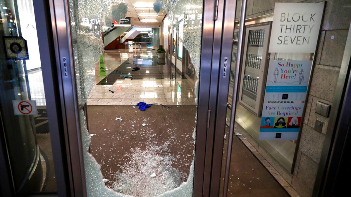 A door to the Block 37 retail building is shattered Monday, Aug. 10, 2020, after vandals struck overnight in Chicago's famed Loop. 