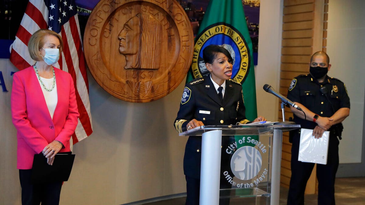 Seattle Police Chief Carmen Best, center, speaks as Seattle Mayor Jenny Durkan, left, and Deputy Police Chief Adrian Diaz, right, look on during a news conference, Tuesday, Aug. 11, 2020, in Seattle.