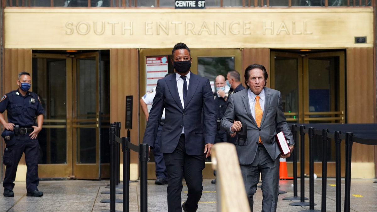 Cuba Gooding Jr. (L) and his attorney Mark J. Heller (R), right, leave court after a hearing in Gooding's sexual misconduct case. 