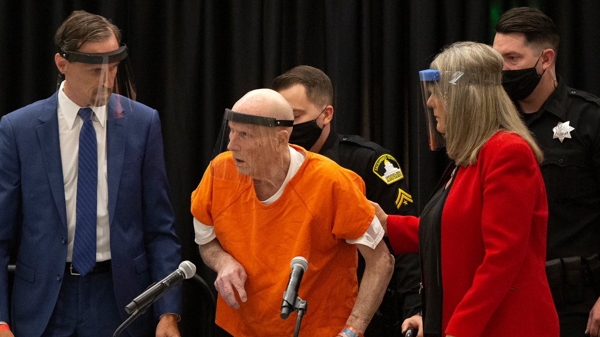 Joseph James DeAngelo, center, charged with being the Golden State Killer, is helped up by his attorney, Diane Howard, as Sacramento Superior Court Judge Michael Bowman enters the courtroom in Sacramento, Calif on June 29, 2020. Survivors plan to confront DeAngelo this week during an extraordinary four days of court hearings before the 74-year-old is sentenced to life in prison. (AP Photo/Rich Pedroncelli, File)