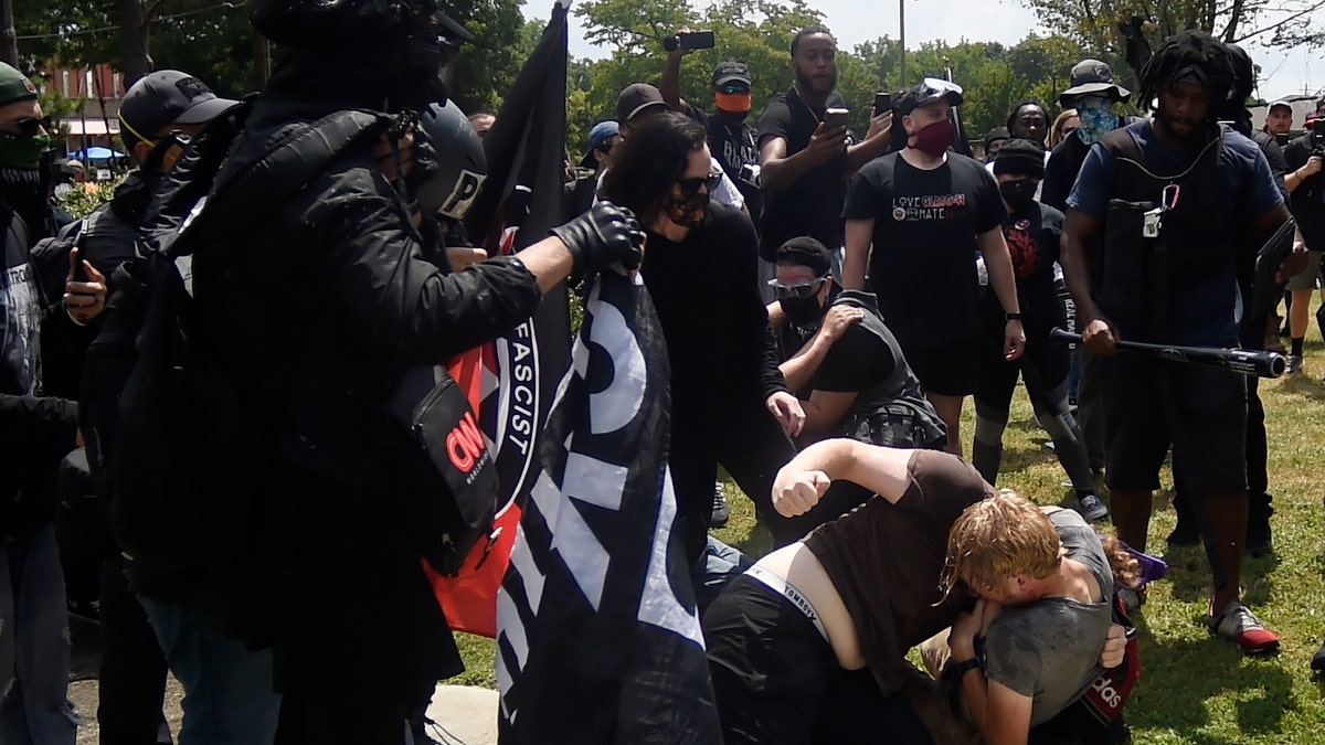 A melee breaks out during a protest, Aug. 15, in Stone Mountain Village, Ga. (AP Photo/Mike Stewart)