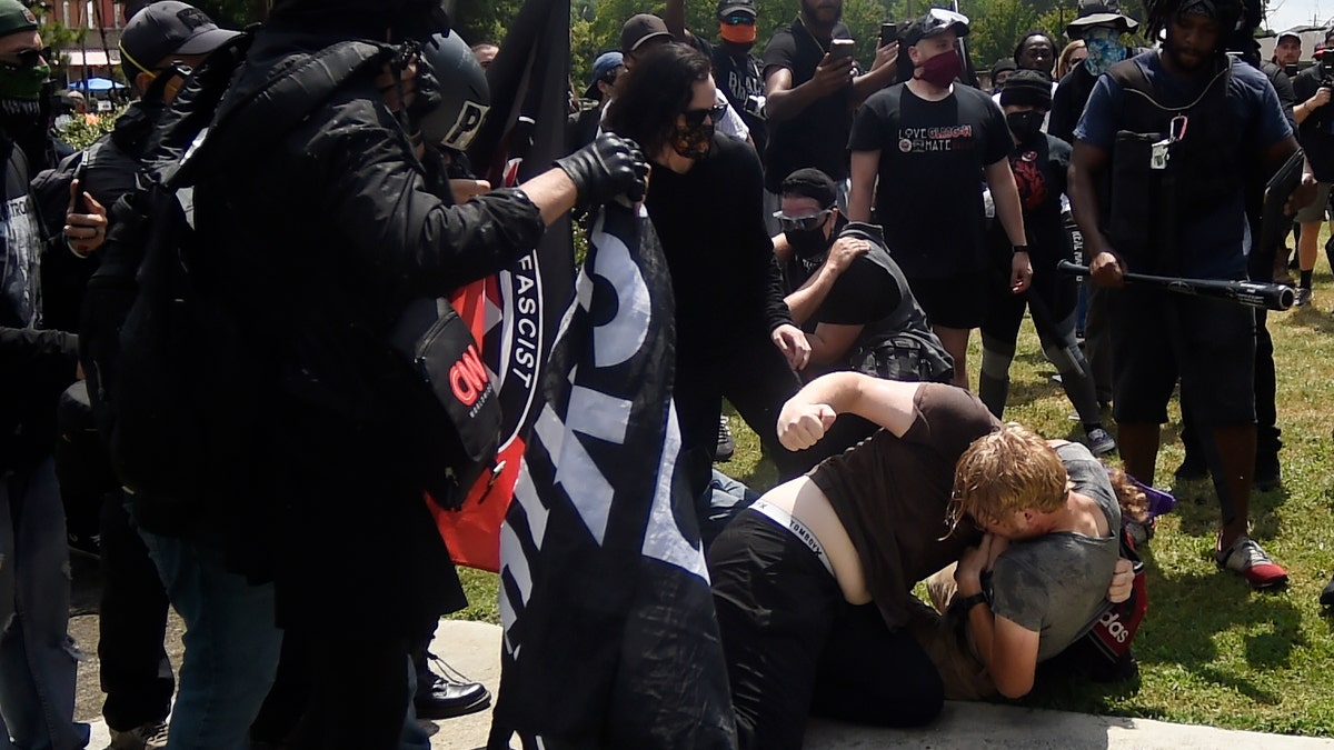 A melee breaks out during a protest, Aug. 15, in Stone Mountain Village, Ga. (AP Photo/Mike Stewart)
