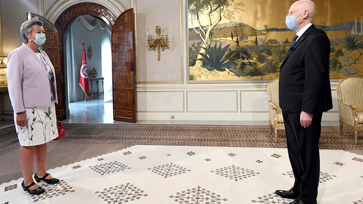 In this photo provided by the Tunisian Presidency, Tunisian President Kais Saied, right, greets European Commissioner for Home Affairs Ylva Johansson in Carthage, near Tunis, Monday, Aug, 17, 2020.