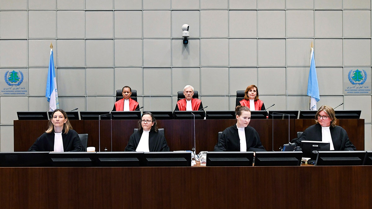 Presiding Judge, Judge David Re, back centre, with Judge Janet Nosworthy, left, and Judge Micheline Braidy, during a session of the United Nations-backed Lebanon Tribunal in Leidschendam, Netherlands Tuesday Aug. 18, 2020, where it is scheduled to hand down it's judgement in the case against four men being tried for the bombing that killed former Lebanon Prime Minister Rafik Hariri and 21 other people. The U.N.-backed tribunal in the Netherlands is to deliver verdicts in the trial held in absentia of four members of the militant Lebanese Hezbollah group accused of involvement in the truck bomb assassination of former Lebanese Prime Minister Rafik Hariri in 2005. (Piroschka Van De Wouw/Pool via AP)