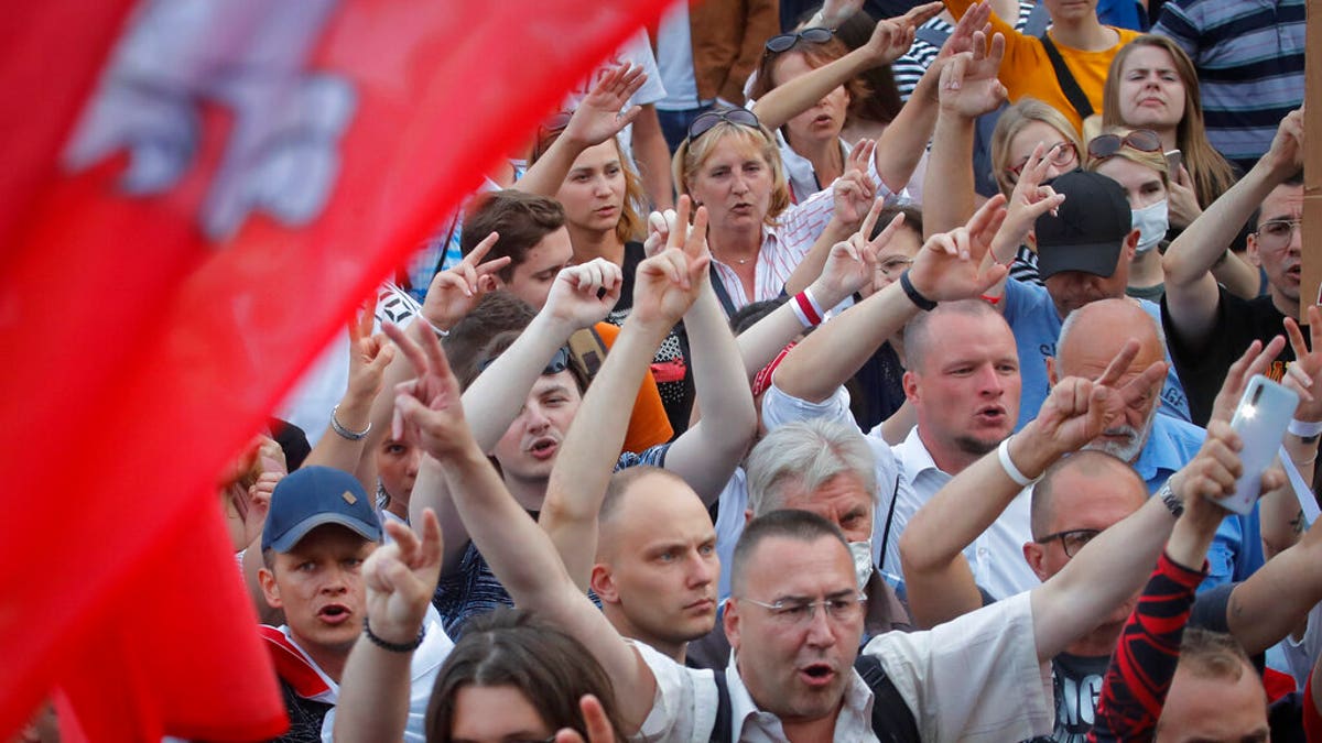 Belarusian opposition supporters shout slogans during a protest rally in front of the government building at Independent Square in Minsk, Belarus, Tuesday, Aug. 18, 2020.
