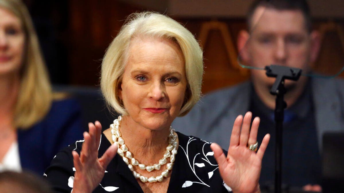 FILE - In this Jan. 13, 2020, file photo Cindy McCain, wife of former Arizona Sen. John McCain, waves to the crowd after being acknowledged by Arizona Republican Gov. Doug Ducey during his State of the State address on the opening day of the legislative session at the Capitol in Phoenix. Cindy McCain is going to bat for Joe Biden, lending her voice to a video set to air on Tuesday, Aug. 18, during the Democratic National Convention programming focused on Biden’s close friendship with her late husband, Sen. John McCain. (AP Photo/Ross D. Franklin, File)