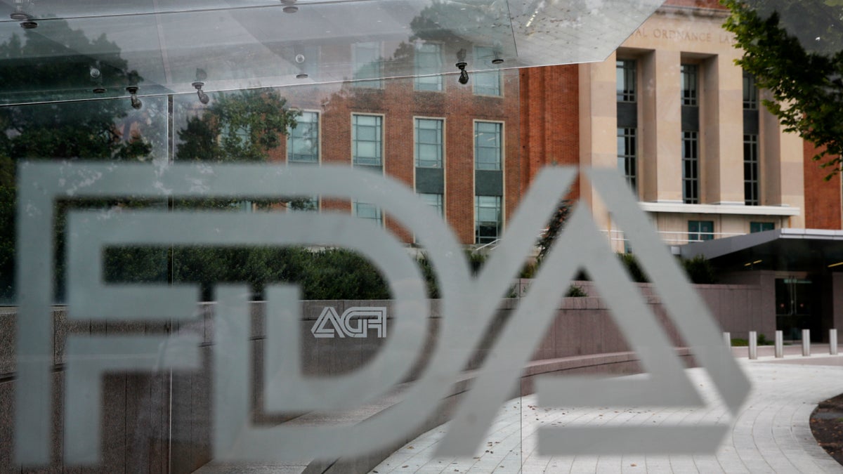 The U.S. Food and Drug Administration building behind FDA logos at a bus stop on the agency's campus in Silver Spring, Md. Aug. 2, 2018. (AP Photo/Jacquelyn Martin, File)